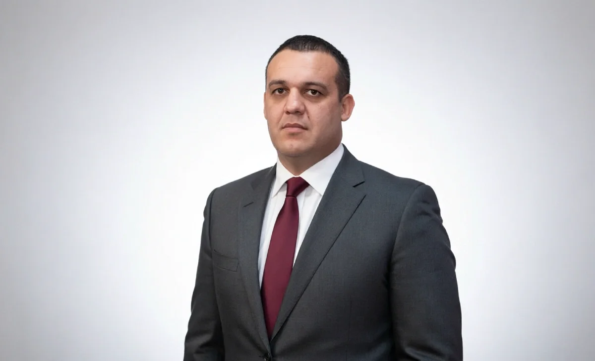 Umar Kremlev, President of IBA, posing near a boxing ring.